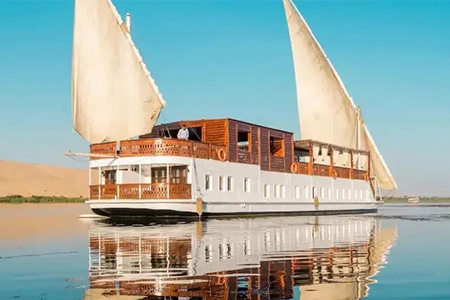 A traditional Egyptian Dahabiya sailing boat on the Nile riverThe Royal Cleopatra Dahabiya cruise ship on the Nile River, Egypt.