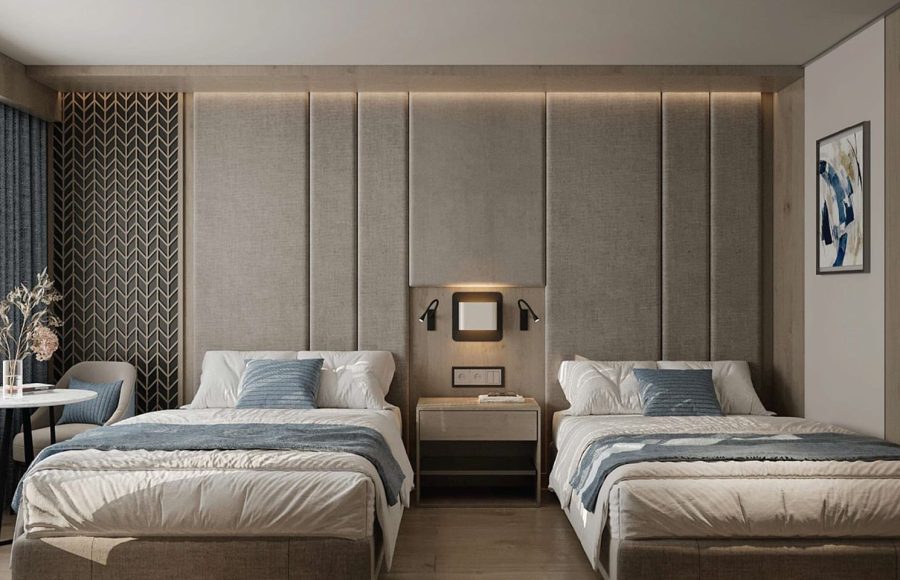 Luxury twin-bed cruise cabin with a large upholstered headboard, a central nightstand, and subtle ambient lighting.