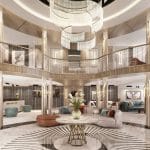 Multi-story luxury cruise lobby with a central chandelier, marble floor with a radial pattern, and modern lounge seating areas.