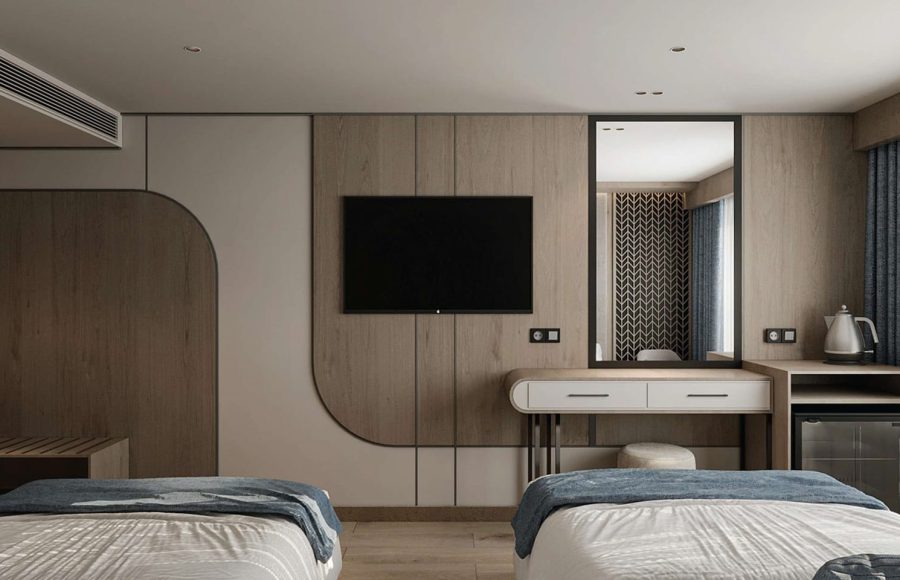 Modern twin-bed cabin interior with a flat-screen TV, wood paneling, and a vanity mirror.