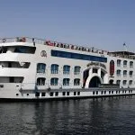 White Nile Cruise ship with blue windows on the water.