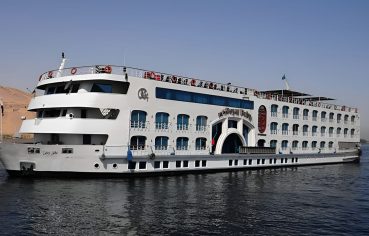 White Nile Cruise ship with blue windows on the water.