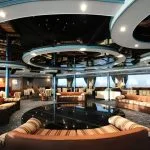 Modern interior lounge and bar area on a cruise ship with circular ceiling design.