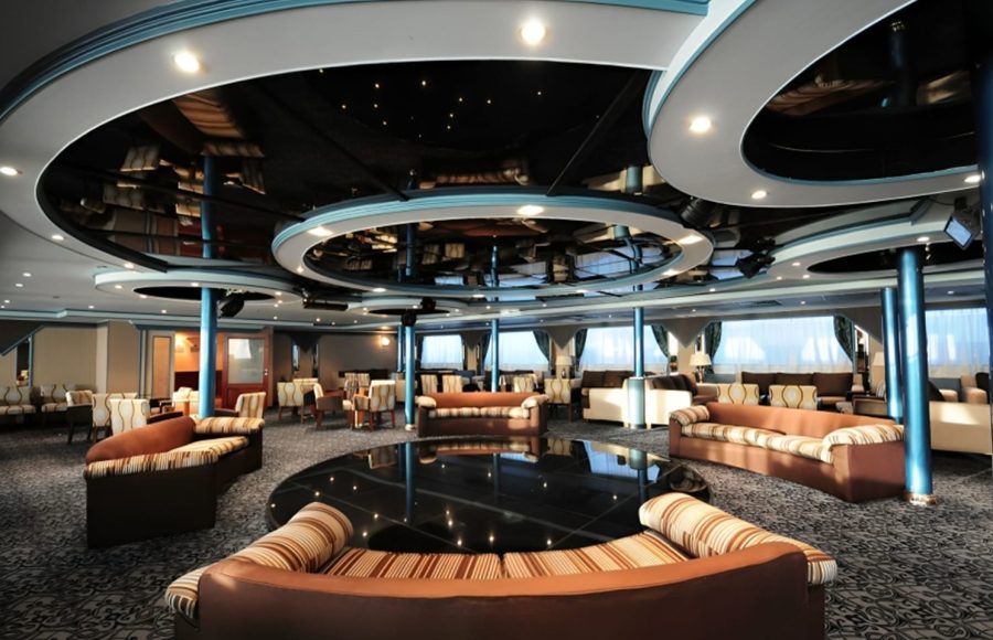 Modern interior lounge and bar area on a cruise ship with circular ceiling design.