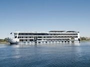 Luxury Nile cruise ship MS Royal Signature sailing on the Nile River on a sunny day.