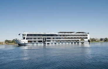 Luxury Nile cruise ship MS Royal Signature sailing on the Nile River on a sunny day.