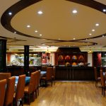 Dining hall on the Royal Viking Nile Cruise featuring a buffet counter and oval ceiling lights.