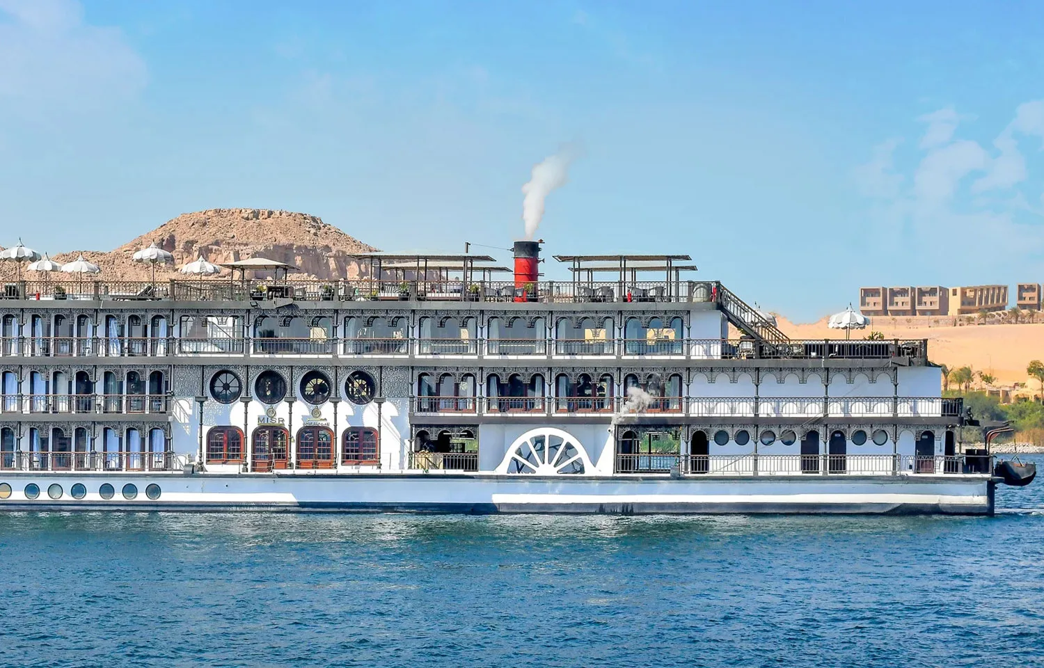 The classic Mövenpick SS Misr Steamer Nile Cruise sailing past desert landscapes.