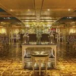 The elegant main lounge and bar area with patterned chairs on the luxurious Sphinx Nile Cruise