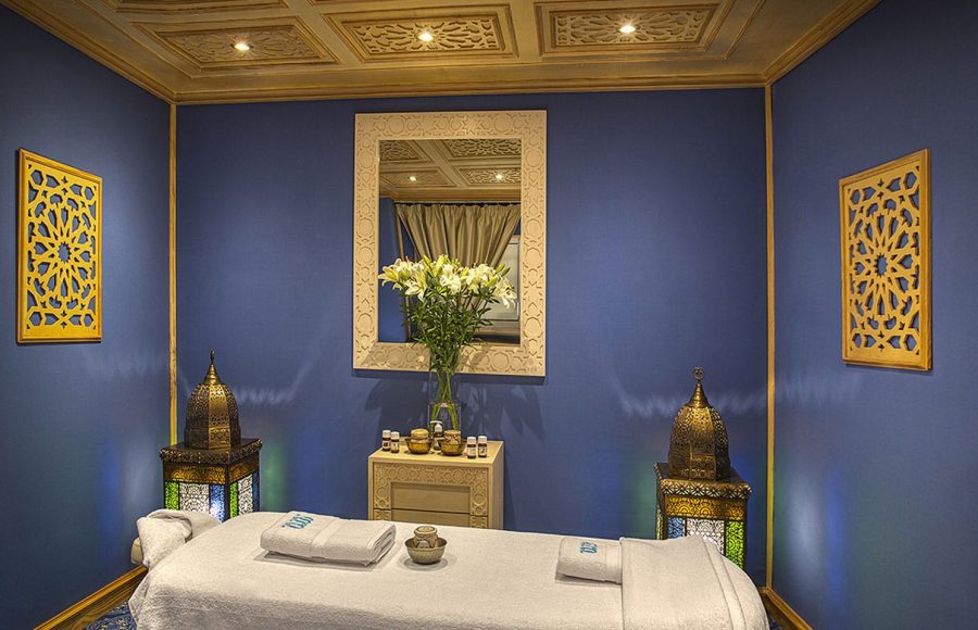 A serene spa treatment room with a massage bed and ambient lighting on the Sphinx Nile Cruise