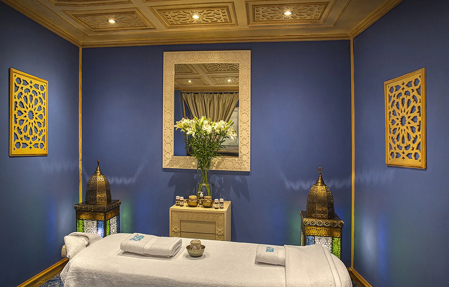 A serene spa treatment room with a massage bed and ambient lighting on the Sphinx Nile Cruise