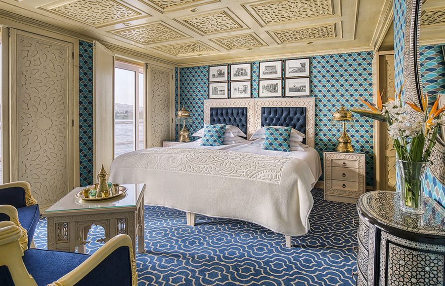 A beautifully decorated Suite with a comfortable bed and river views on the Sphinx Nile Cruise