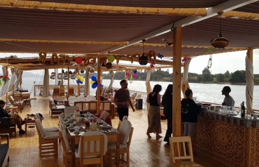A picture of the Sacred Lotus Dahabiya cruise sundeck set up for dining on the Nile River.