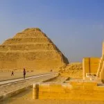 A wide view of the historic Step Pyramid during a Saqqara and Grand Egyptian Museum tour under a clear blue sky