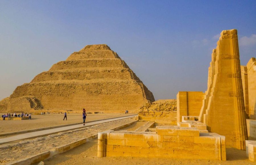 A wide view of the historic Step Pyramid during a Saqqara and Grand Egyptian Museum tour under a clear blue sky