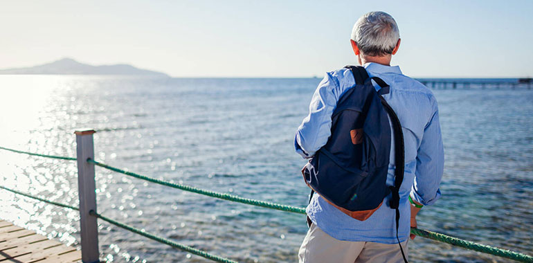 Senior Man With Backpack Admiring Landscape Of Red Sea