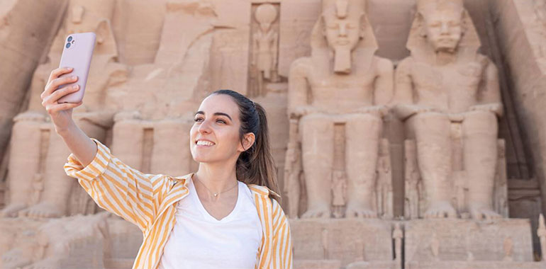 Smiling Happy Woman Taking A Selfie As Tourist In Abu Simbel Egypt