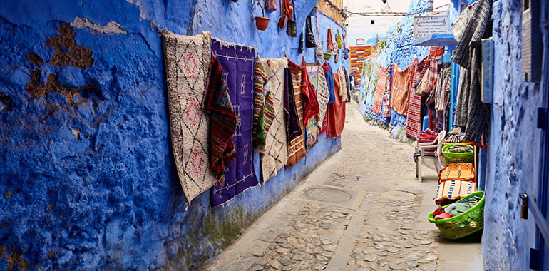 Street with handmade Maroccan rugs in Chefchaouen Morocco