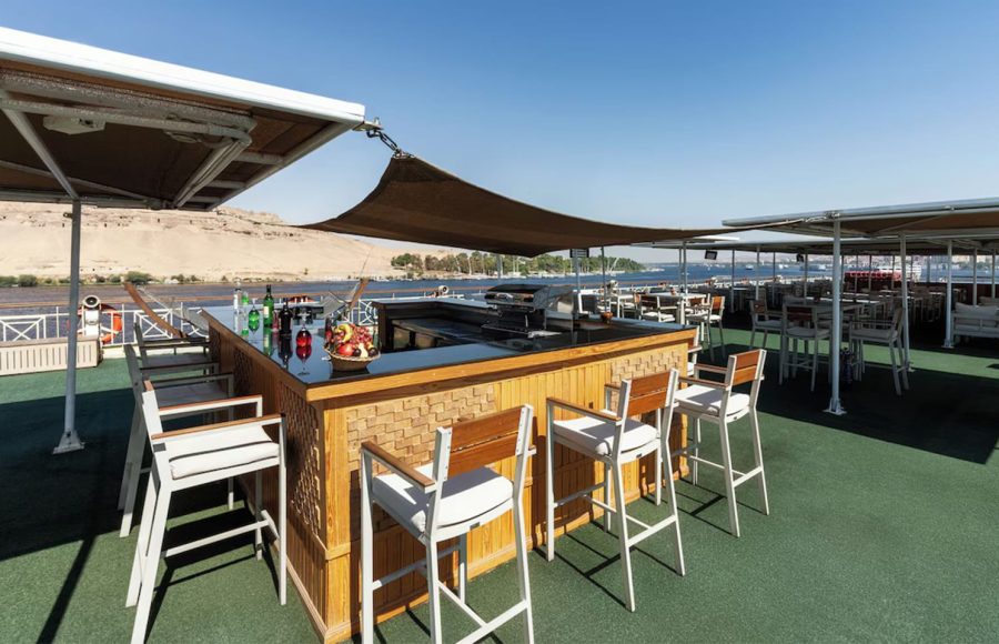 Wooden bar with high chairs on a Nile cruise ship sun deck.