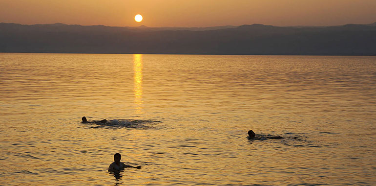 Swimming In The Dead Sea At Sunset Jordan
