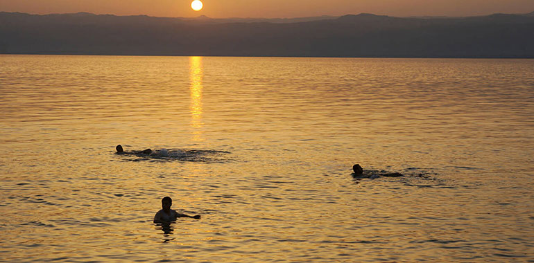Swimming In The Dead Sea At Sunset In Jordan 1