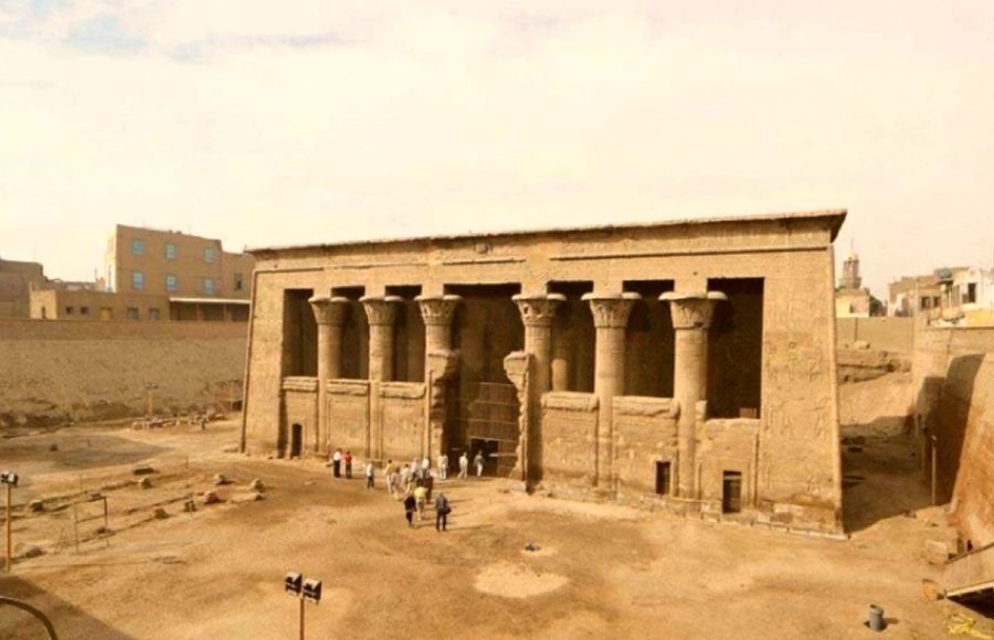 The ancient Temple of Khnum in Esna, featuring a grand facade with massive sandstone columns under a bright sky.