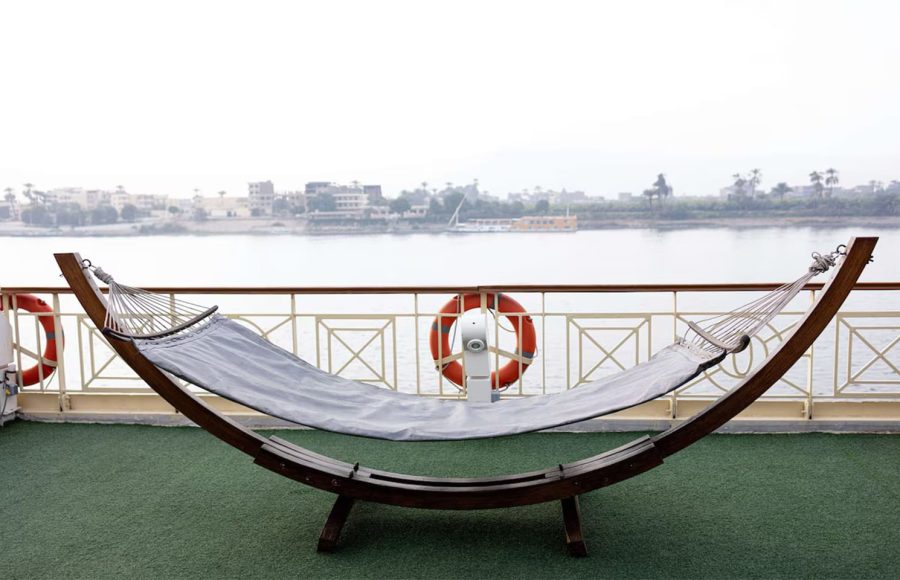 Hammock on cruise ship deck overlooking the Nile River.