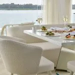 A gourmet breakfast spread on a white marble table overlooking the Nile River.