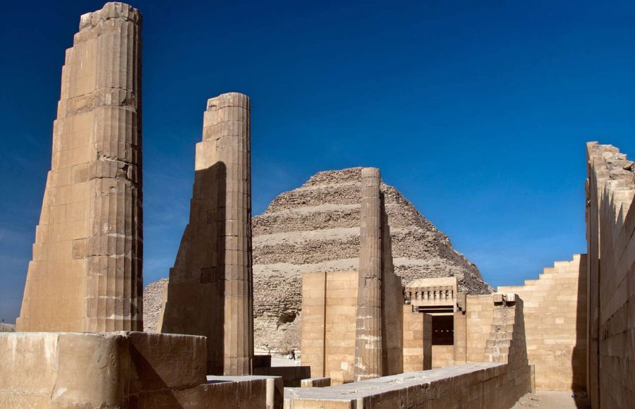 The well-preserved stepped facade and entrance gate with stone columns of The Step Pyramid of Zoser in Saqqara Egypt, a key historic stop on a typical 7 day egypt itinerary with beach.