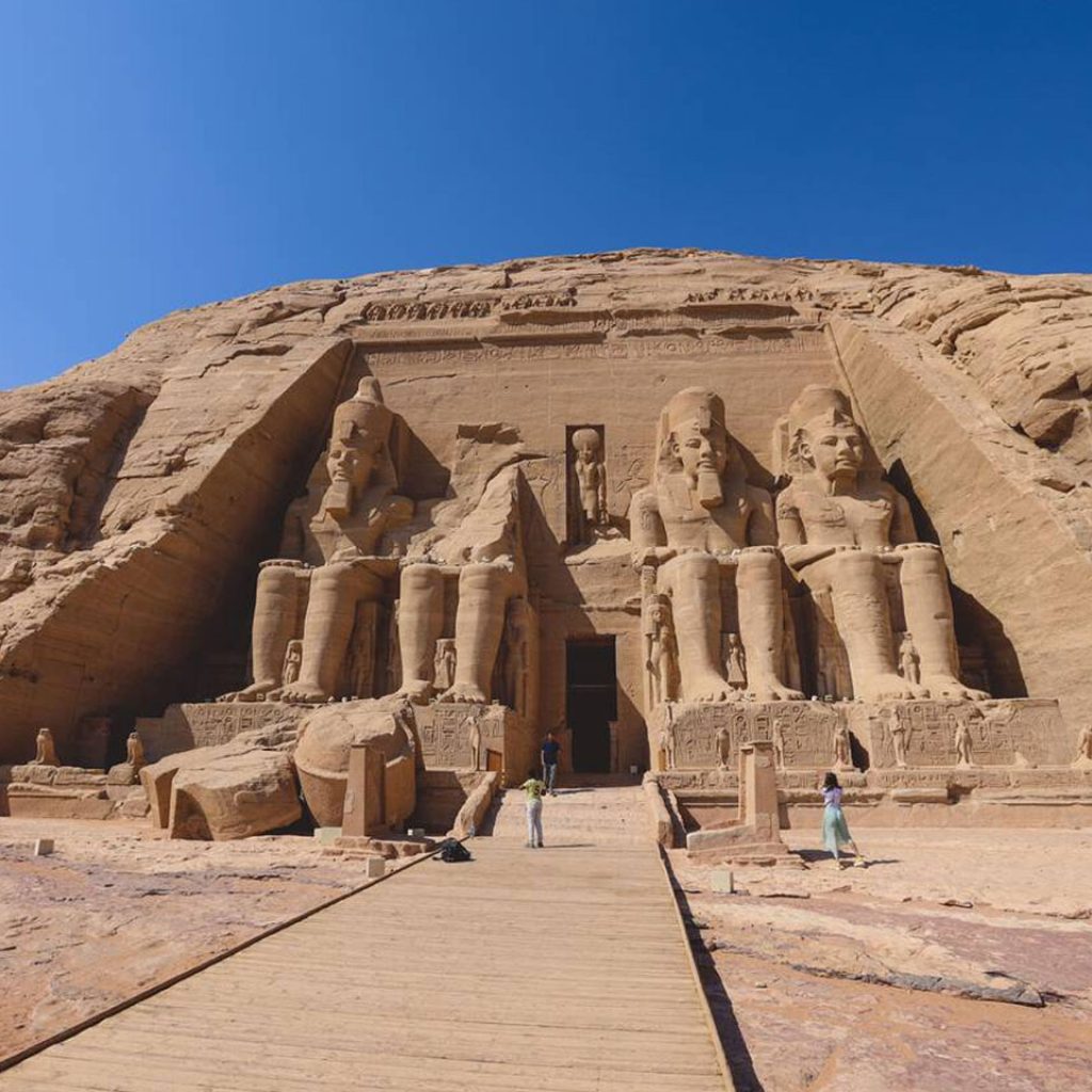 The main view of an Entrance to the Great Temple at Abu Simbel with Ancient Colossal statues of Ramesses II seated on a throne