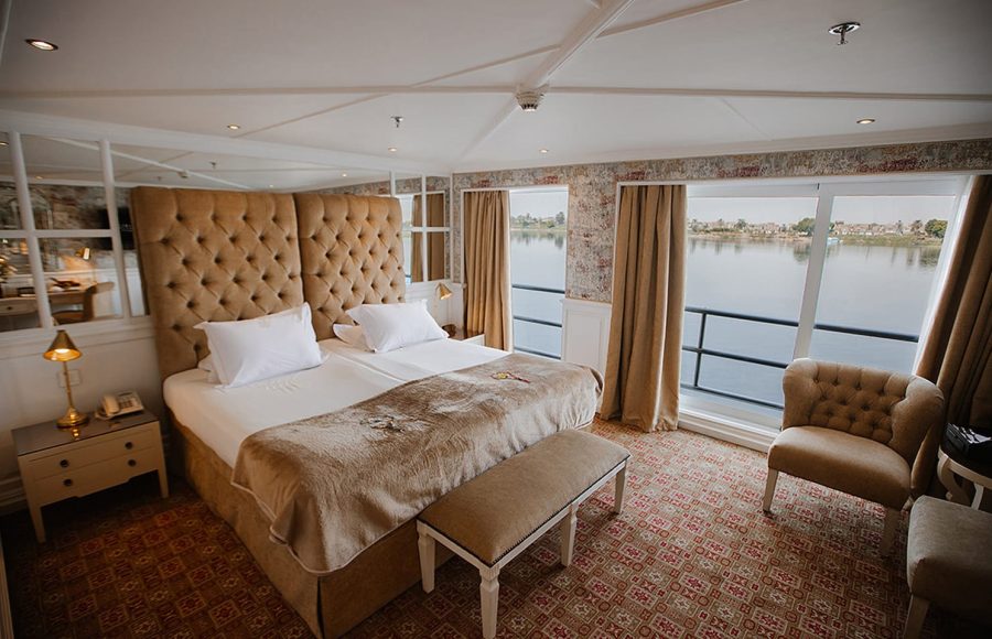 Luxurious king suite on Tosca Nile Cruise with river view.