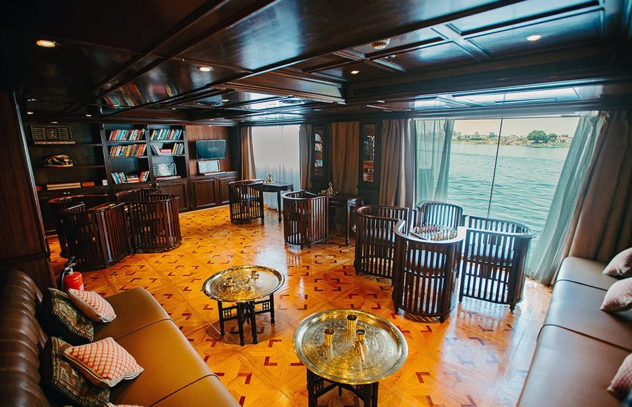 Interior of a dark wood library/lounge on a Nile cruise ship.