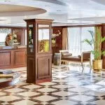 Interior of the elegant lobby on a Nile cruise ship with marble floors and dark wood accents.