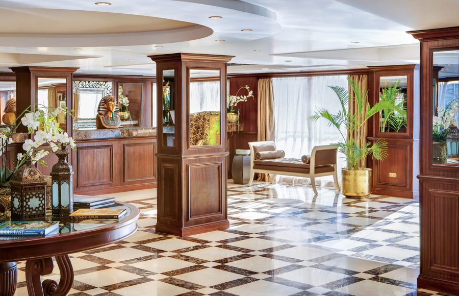 Interior of the elegant lobby on a Nile cruise ship with marble floors and dark wood accents.