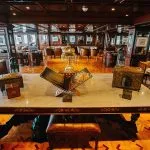Interior of a dark wood lounge on a Nile cruise ship with a decorative centerpiece table.