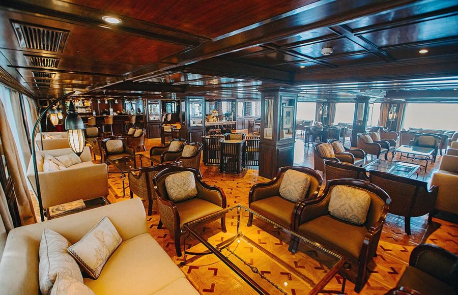 Interior of a dark wood lounge and bar area on a Nile cruise ship.