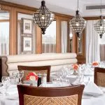 Dark wood library interior on a Nile cruise ship with seating areas and bookshelves.