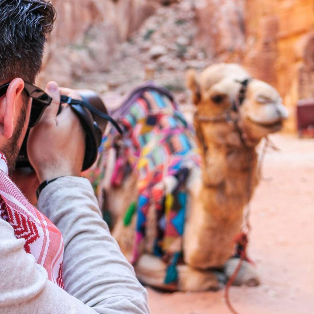 Tourist Photographs A Camel In Petra Jordan
