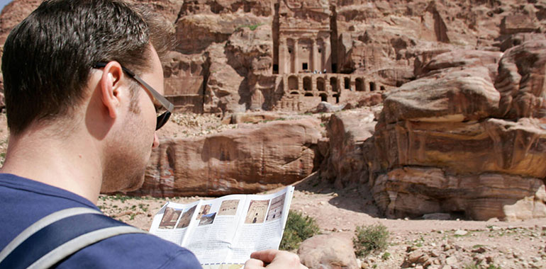 Tourist Reading Map In Front Of Tomb Petra National Park Jordan