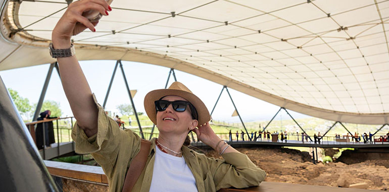 Tourist woman visits famous historical cities and takes photos there Gobeklitepe Sanliurfa Turkey