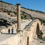 Tourists-cross-the-ancient-Roman-Cendere-bridge-which-crosses-the-Cendere-River-near-the-town-of-Kocahisar-in-Turkey