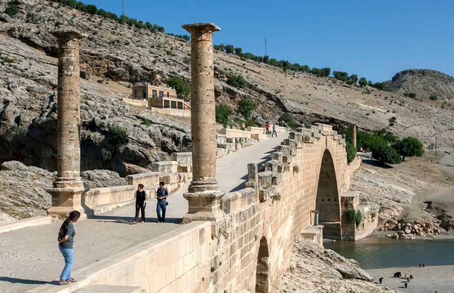 Tourists-cross-the-ancient-Roman-Cendere-bridge-which-crosses-the-Cendere-River-near-the-town-of-Kocahisar-in-Turkey
