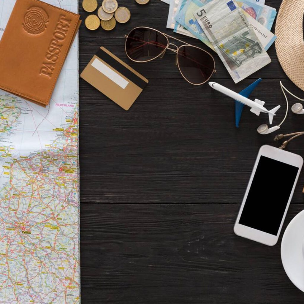 Travel Planning Includes A Map Passport Money Phone And Coffee On A Wooden Table