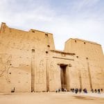 Tourists standing before the massive pylon of Edfu Temple an impressive stop on Upper Egypt Tours