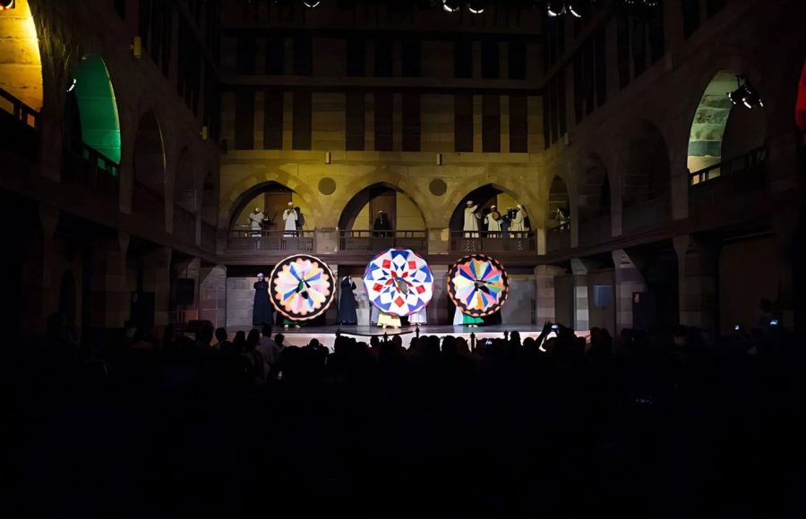 Vibrant Sufi dancers spinning during a traditional Wekalet El Ghouri performance in Old Cairo
