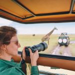 Woman-enjoying-safari-with-elephants-during-sunset-Maasai-Mara-National-Park,