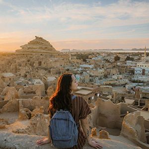 Woman looking at scenic view of Siwa oasis at sunset during her egypt and turkey tour 15 days siwa oasis gobeklitepe cairo alexandria