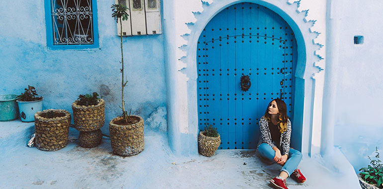 Woman sitting near the doors in Chefchaouen