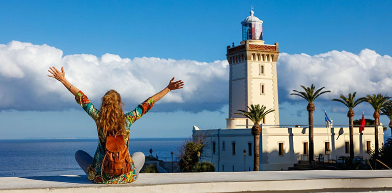 Woman tourist looking at lighthouse of Cap Spartel Tanger Morocco