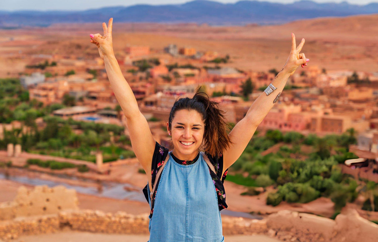 Young tourist visiting Ait Benhaddou Ancient city in Morocco